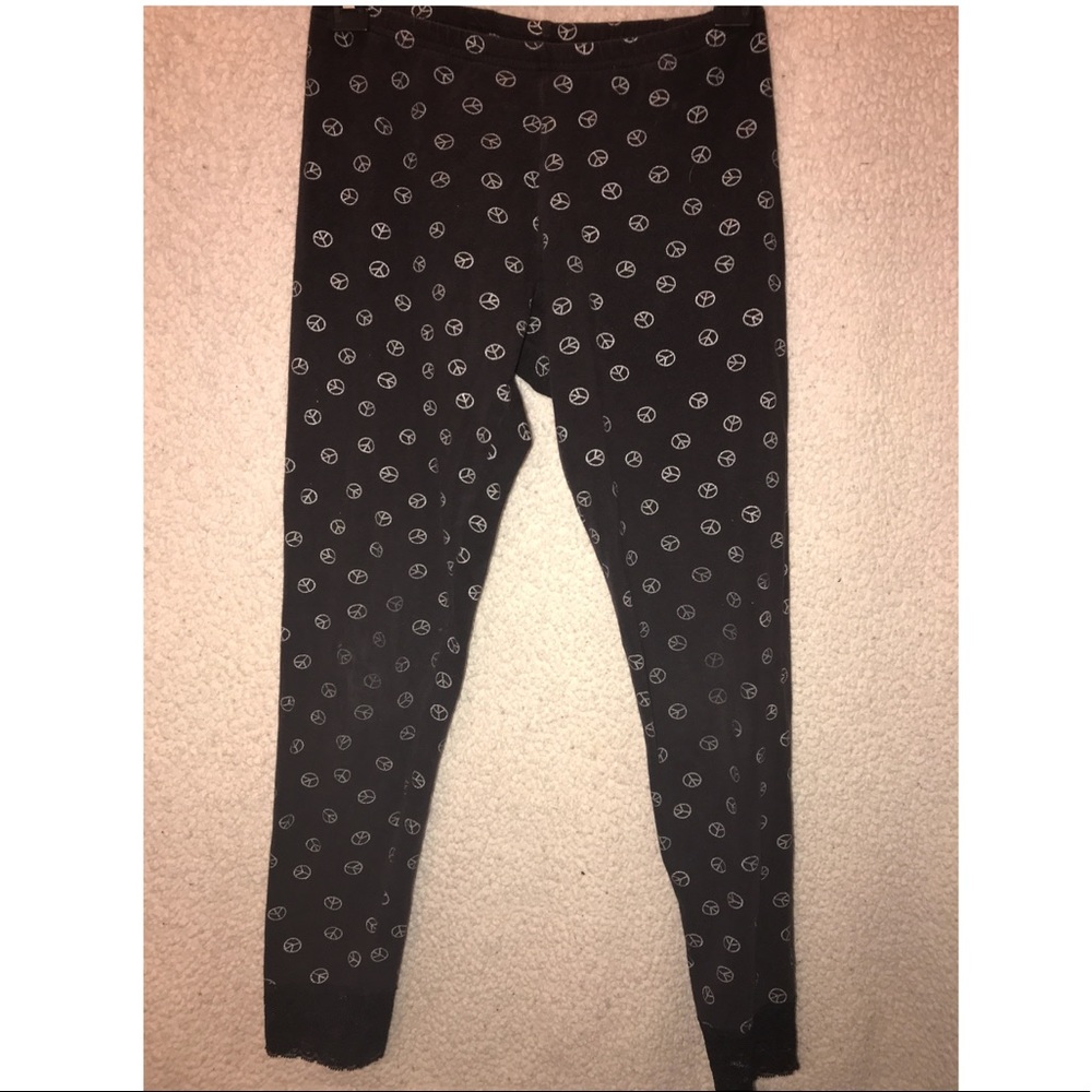 Black leggings with silver peace signs